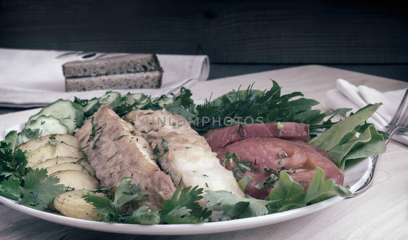 Fried fish with potatoes, vegetables and herbs by georgina198