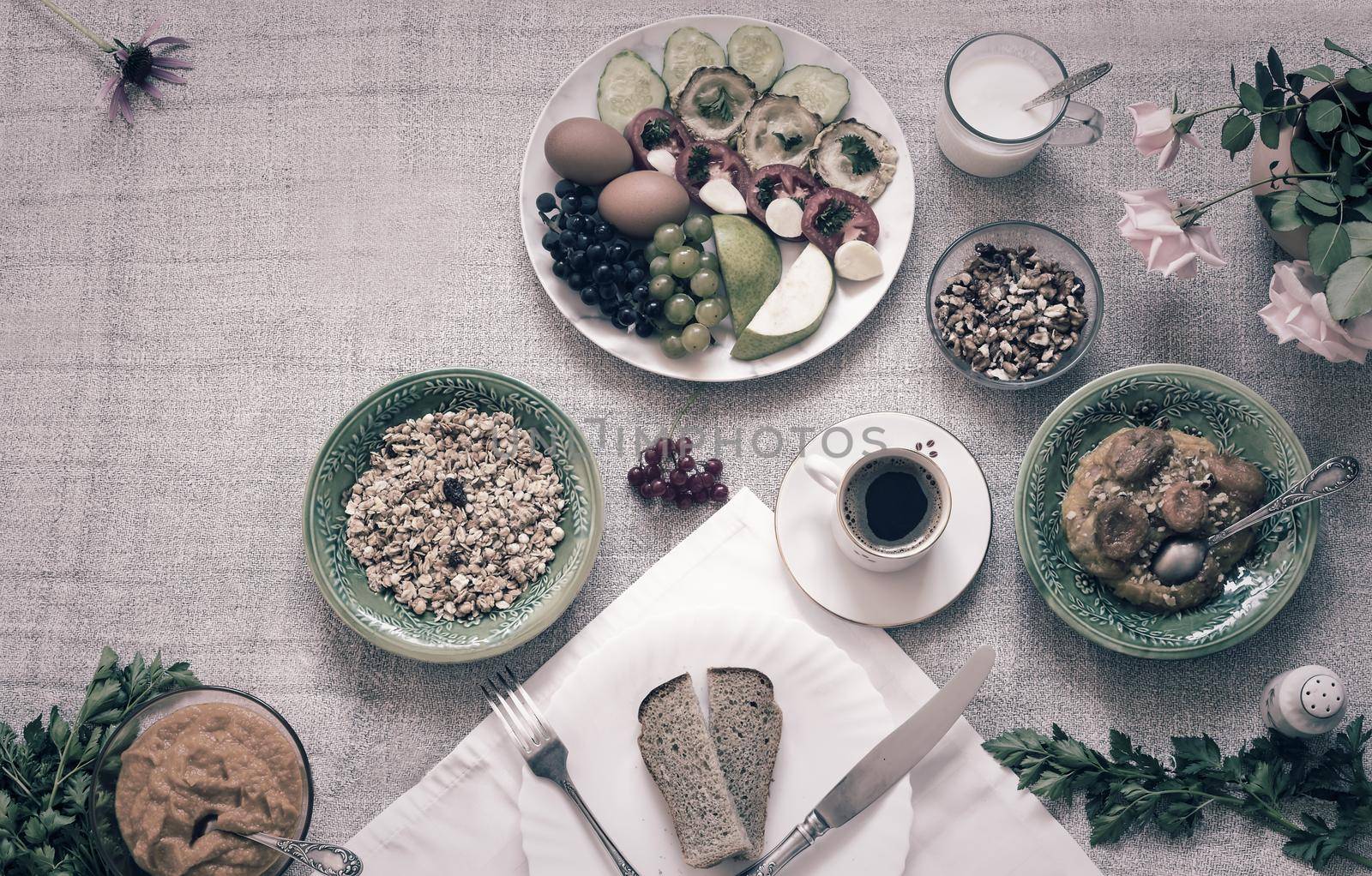 Healthy Breakfast: pumpkin puree with dried apricots, muesli, kefir, vegetables, eggs, coffee. Presented on a homespun rustic tablecloth, top view, copy space.