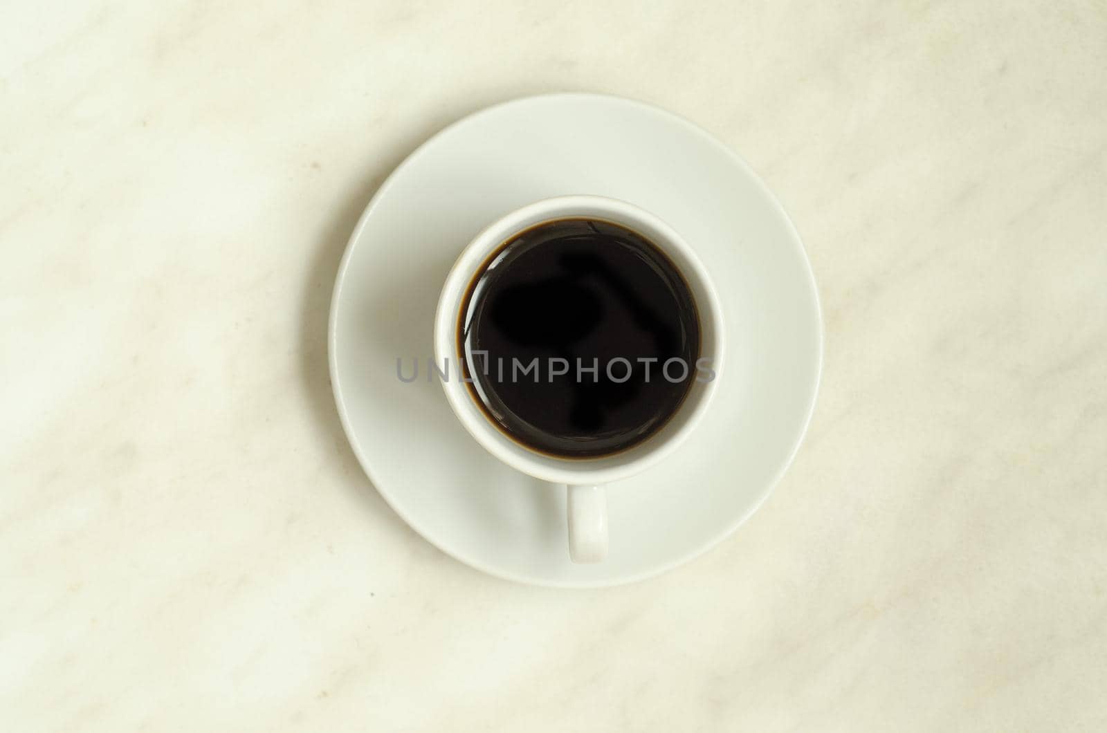 Top view, a cup of coffee on white surface.Morning coffee by andre_dechapelle