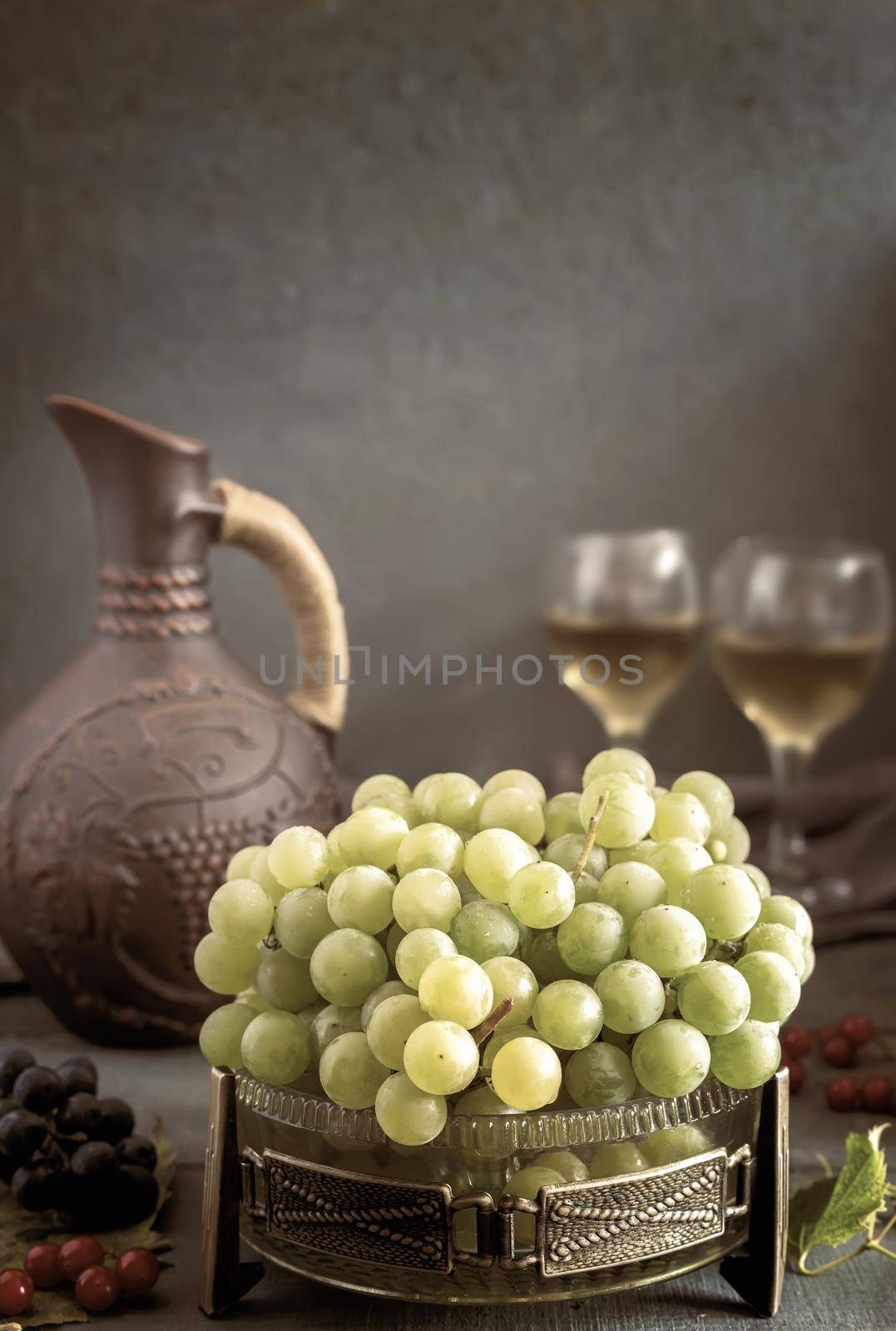 Grapes and wine in a jug and glasses by georgina198