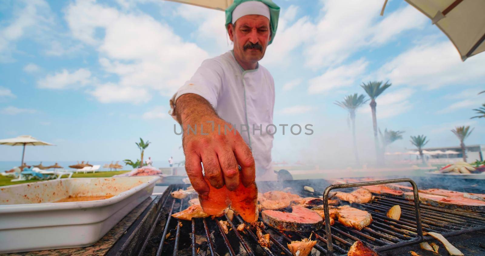 Chef cooking grilled salmon fillets by RecCameraStock