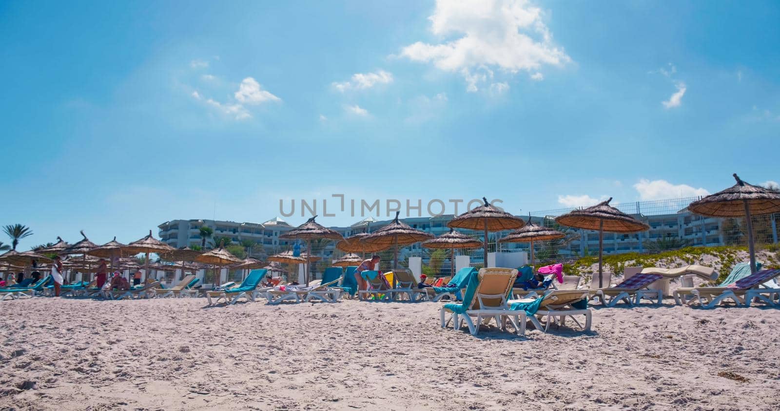 People relax on Mediterranean Sea beach by RecCameraStock