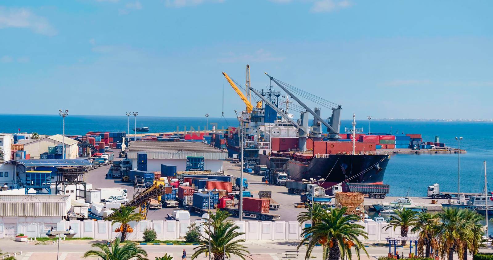 International containers cargo ship loading and unloading in Port of Sousse, Tunisia. Freight transportation, shipping, nautical vessel. Oversea Transport business