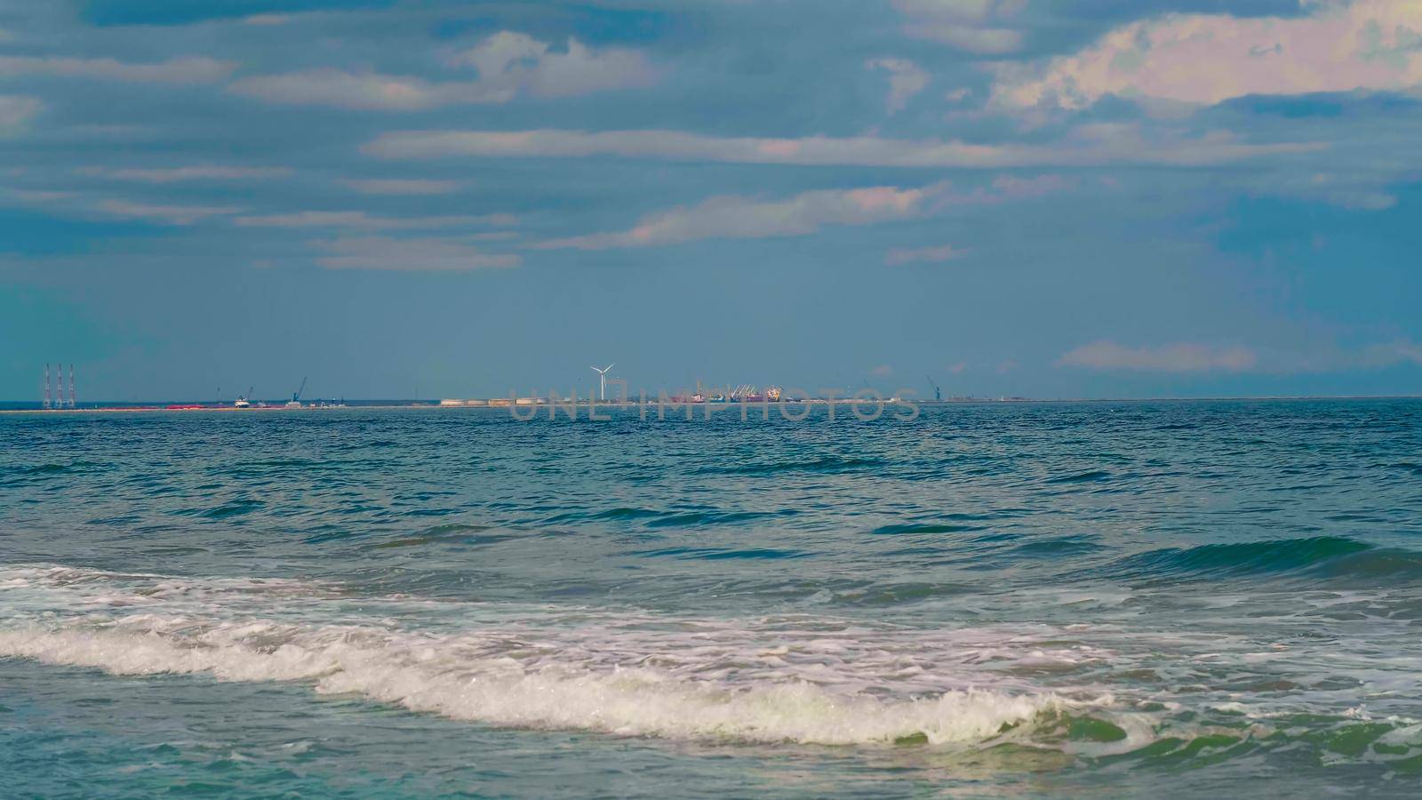 Wind energy at Black sea seashore. Renewable energy generated by wind turbines. Green tech.