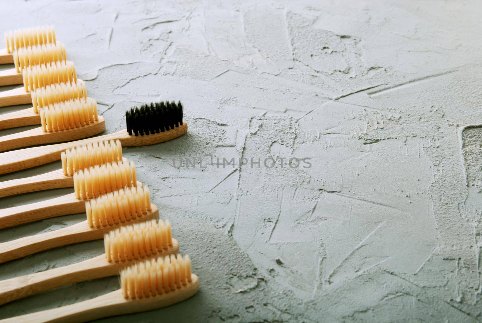 bamboo toothbrushes on a concrete background with copy space by maramorosz