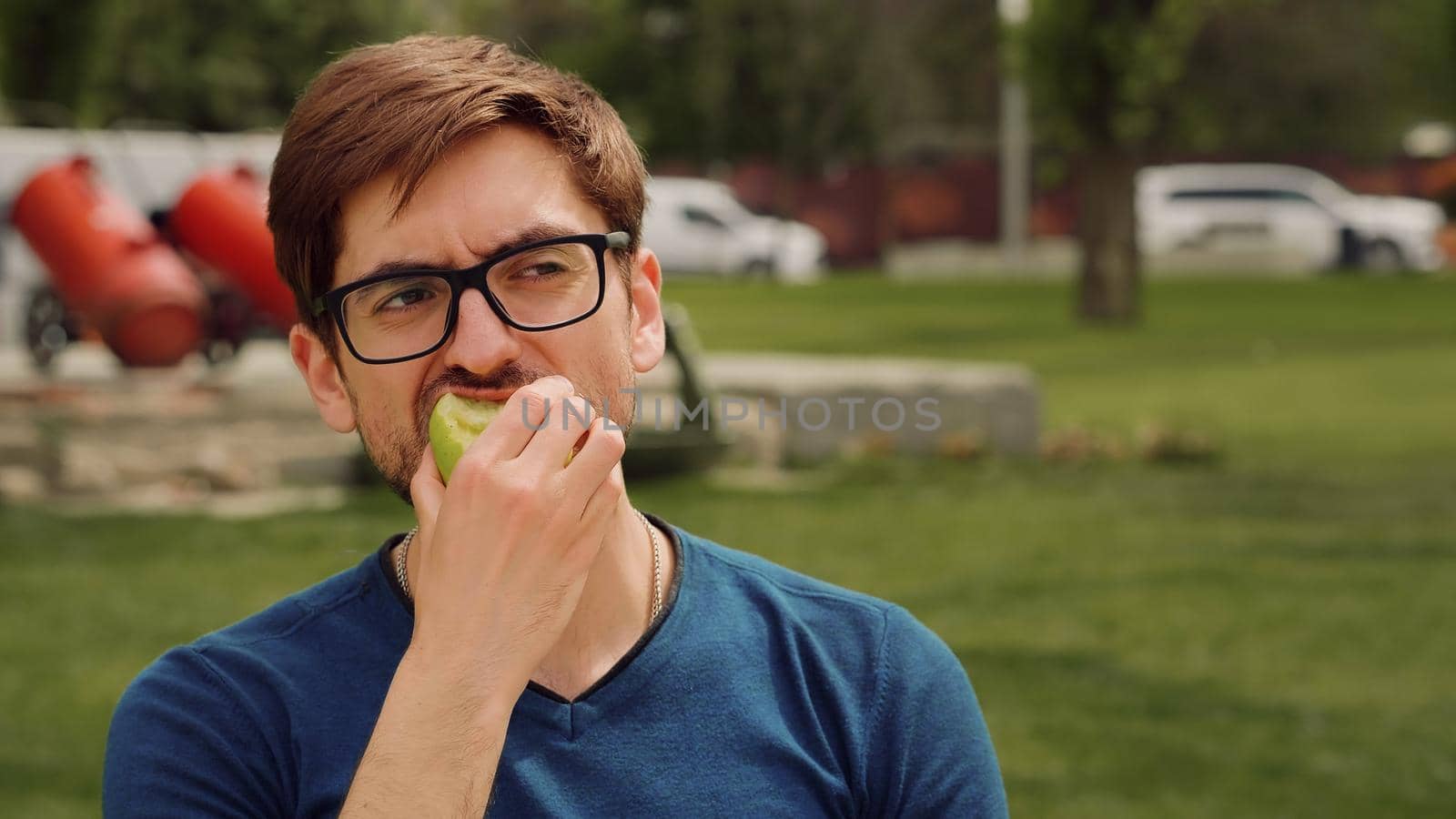 Young man Eating a apple as snack. Heathy food Concept.