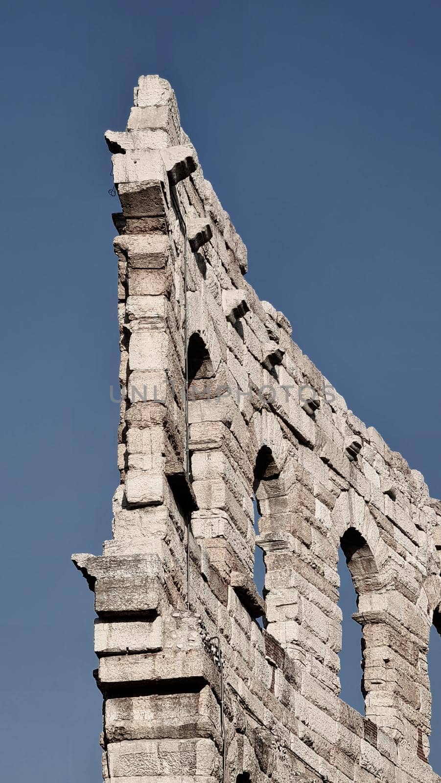 Verona, Italy - March 19, 2022: Beautiful photography of the Arena at Piazza Brà in Verona, a famous Roman amphitheater. Macro view of the old construction by day.