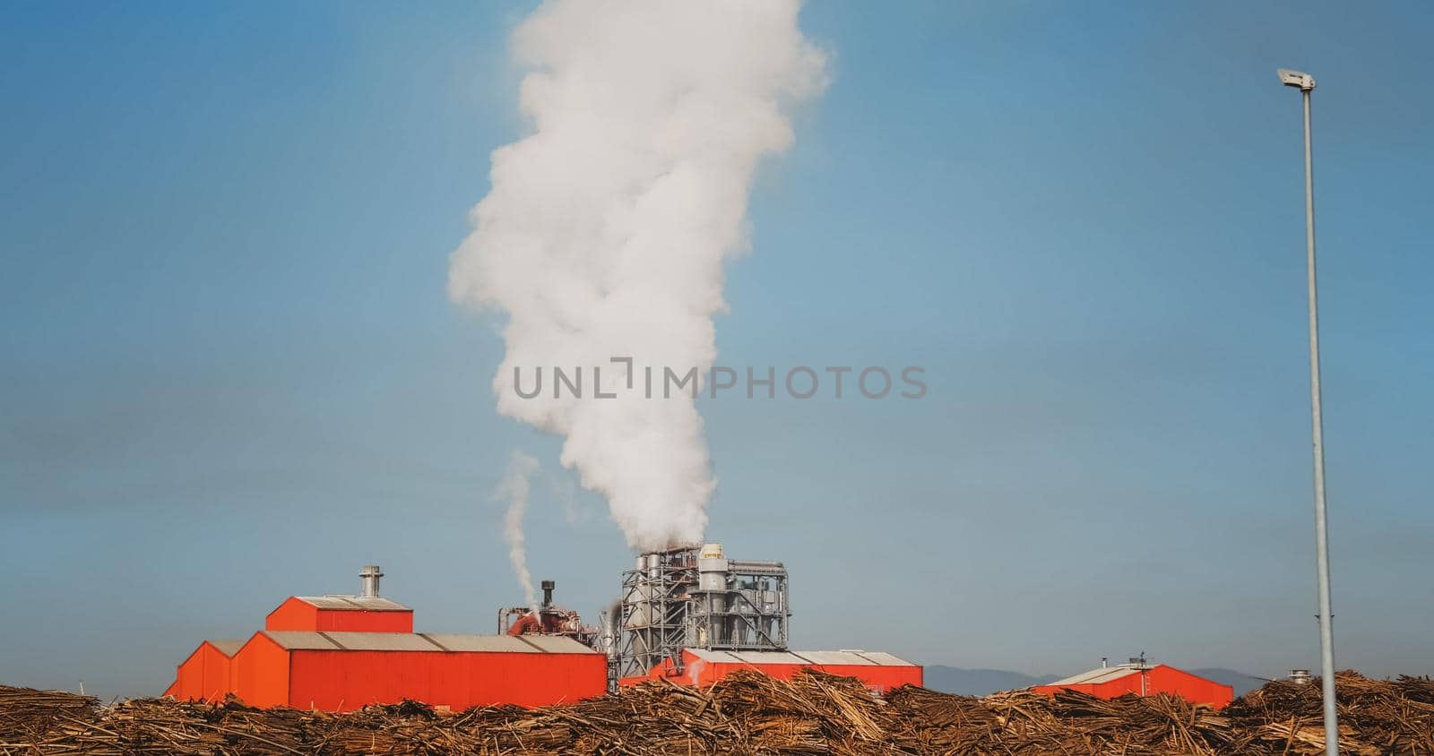 Industrial zone thick white smoke in morning. Pollution of the environment a pipe with smoke.