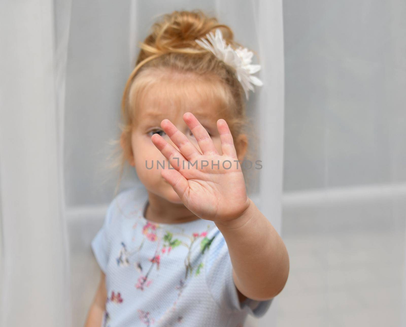 The little girl covers her face with her hand. Please, no picture.