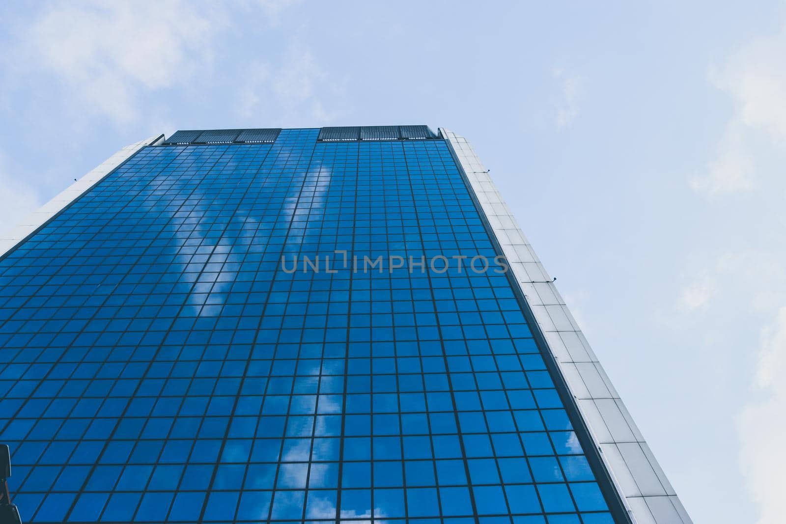Genova, Italy-January 29, 2022: Beautiful modern high-rise buildings against the sky. 3d illustration on the theme of business success and technology. clouds reflection on the mirror.Industrial zone.