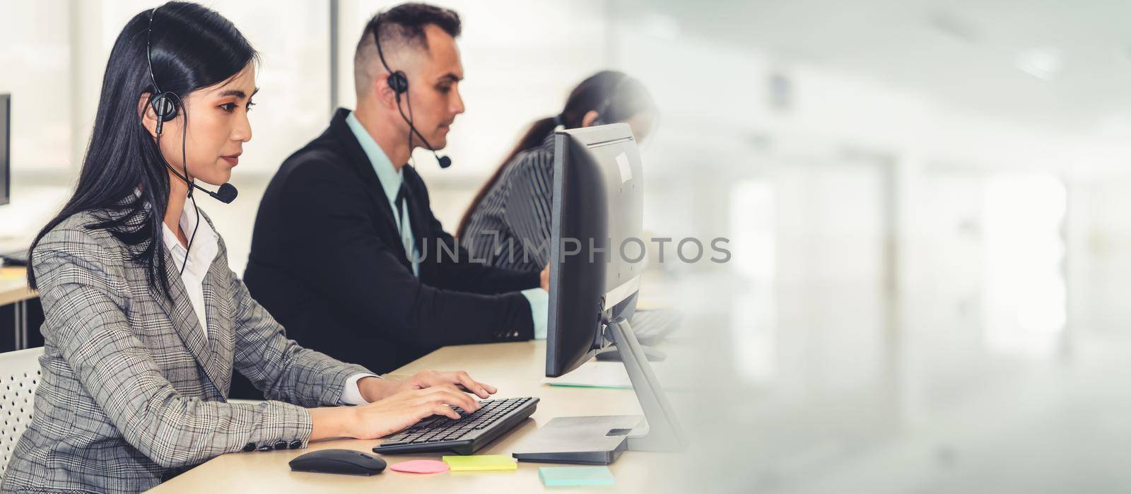 Business people wearing headset working in office broaden view by biancoblue