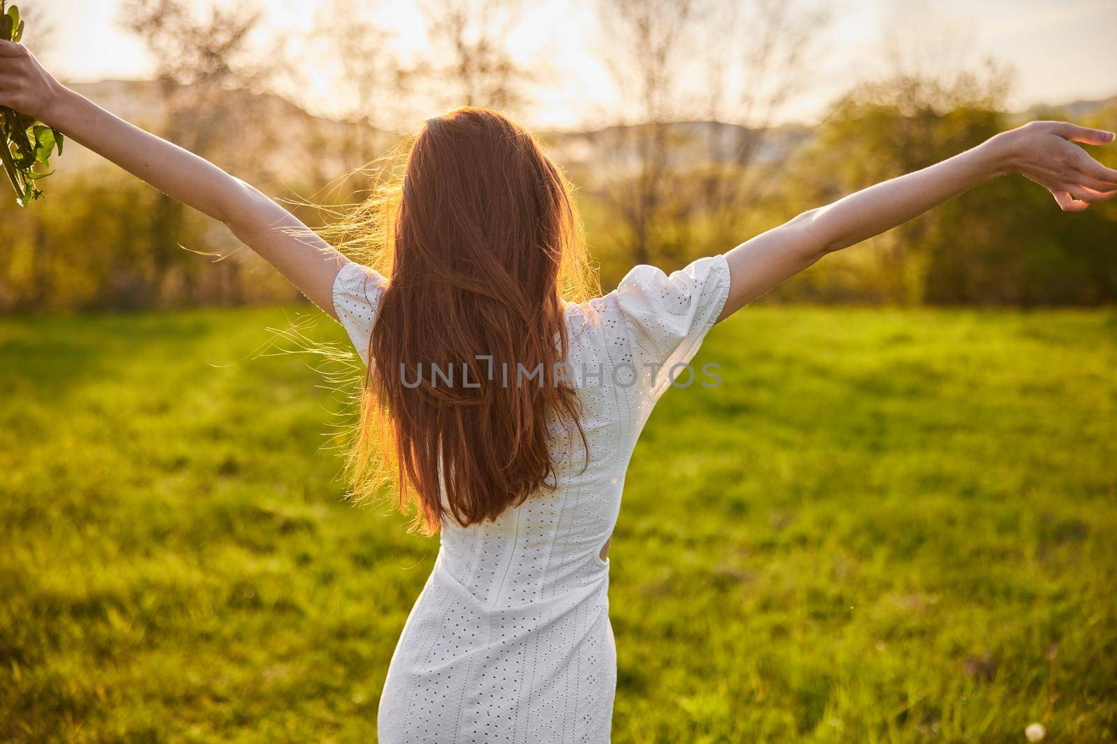 joyful girl at yellow rape seed meadow on sun set. High quality photo