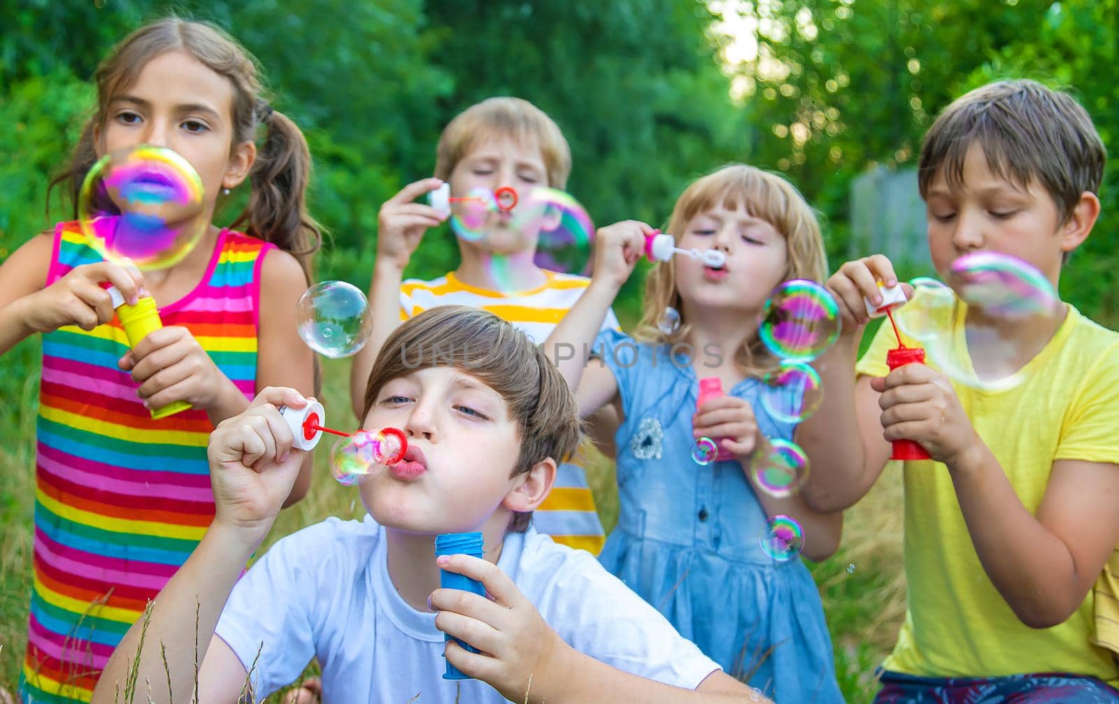 Children blow bubbles in the street. Selective focus. nature.