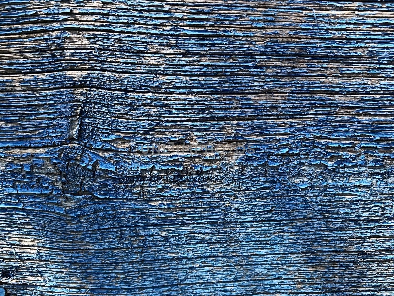 background texture of old wood with peeling blue paint