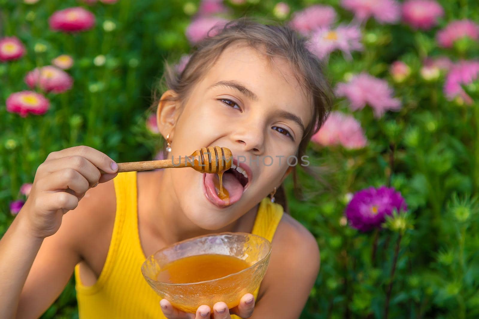 The child eats flower honey. Selective focus. Nature.