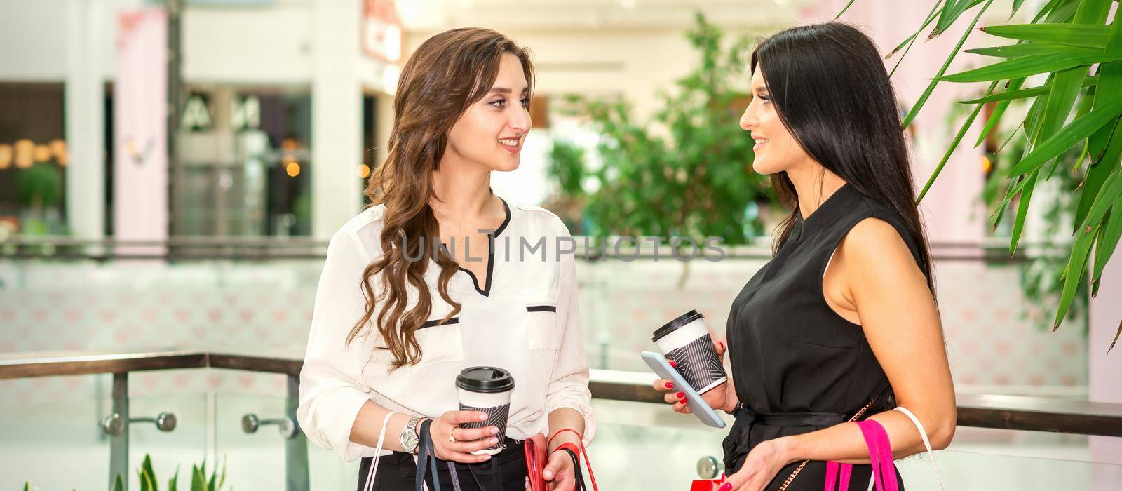 Two young women at shopping mall by okskukuruza