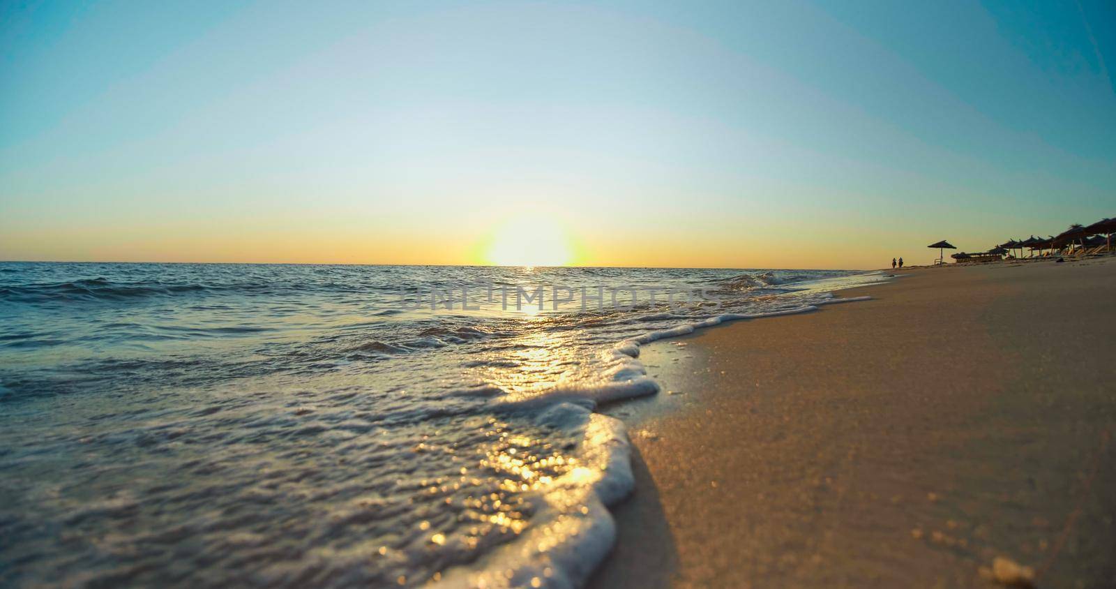 Shining golden waves close up. Sunset on the beach. Beautiful landscape, travel destinations, enjoying holiday, vacation seaside.