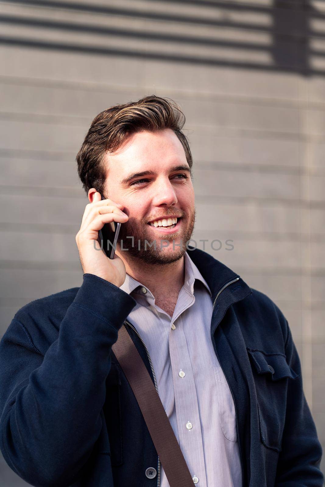 smiling caucasian man entrepreneur talking by phone, concept of entrepreneurship and business, copy space for text