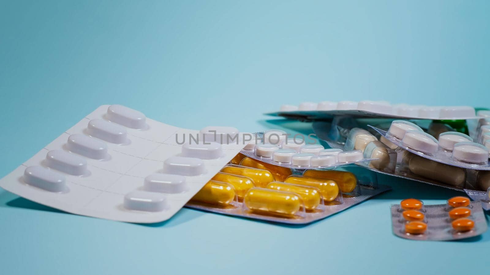 Medicine Pills On A Blue Background. by RecCameraStock