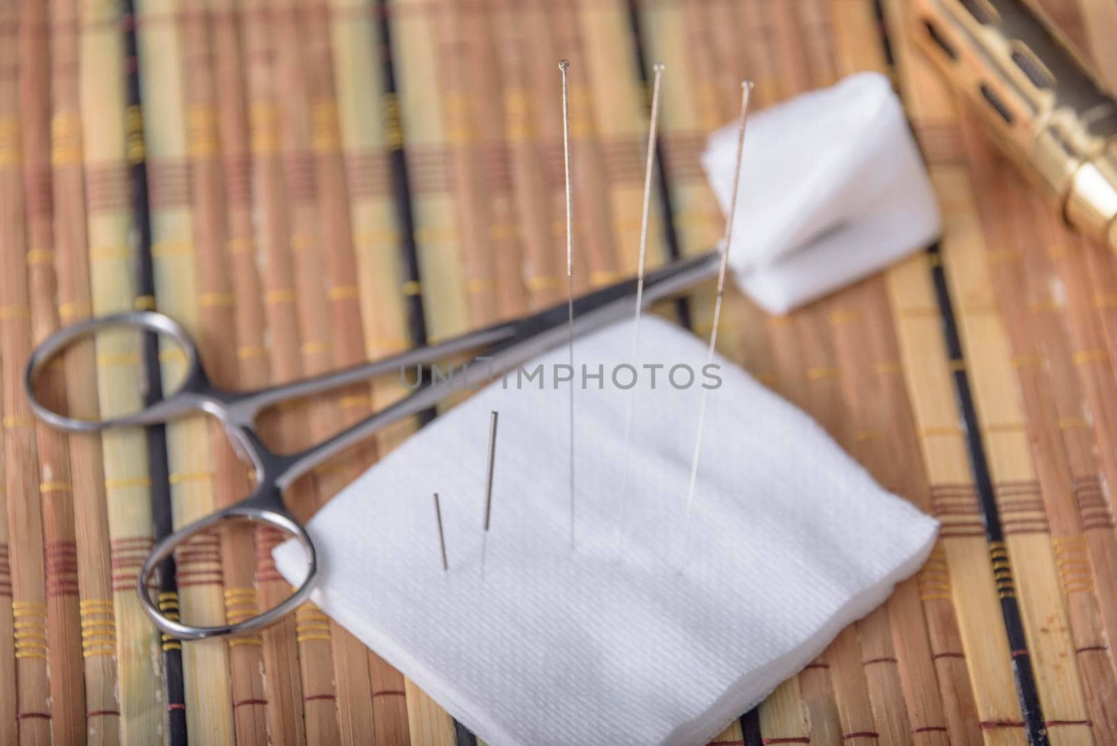 Cork coaster with acupuncture needles on black table, closeup. by jbruiz78