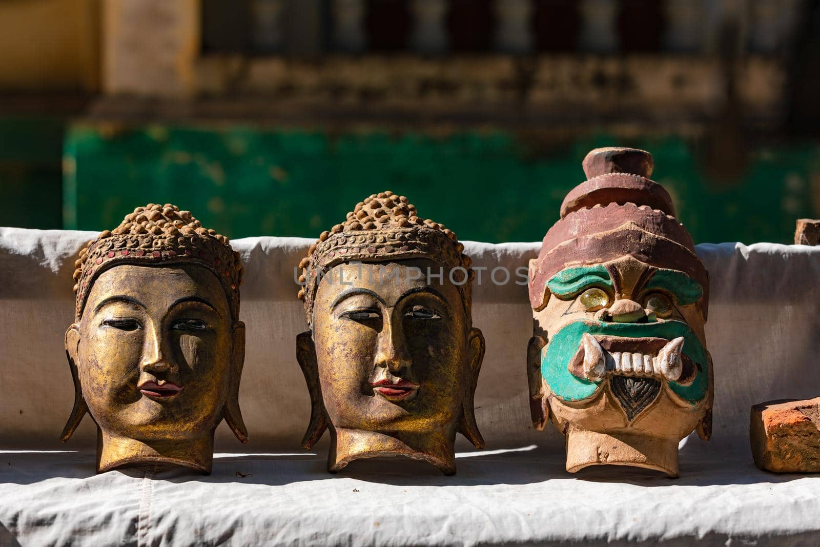 A stall selling Buddhist masks in front of an ancient temple in Myanmar