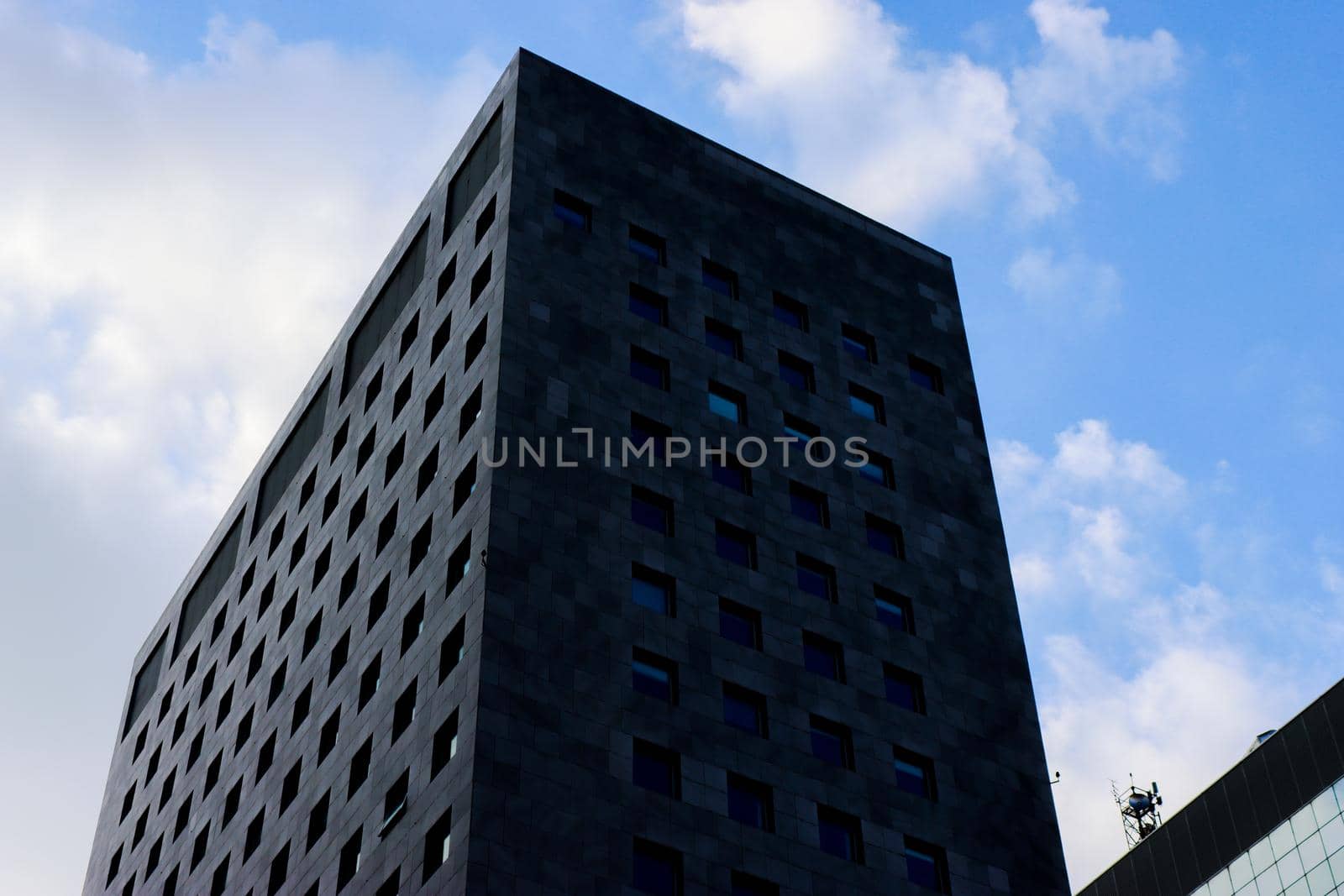 Genova, Italy-January 29, 2022: Beautiful modern high-rise buildings against the sky. 3d illustration on the theme of business success and technology. clouds reflection on the mirror.Industrial zone.