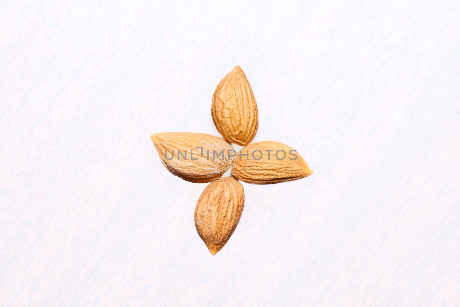 A softer, usually edible part of a nut, seed, or fruit stone contained within its hard shell