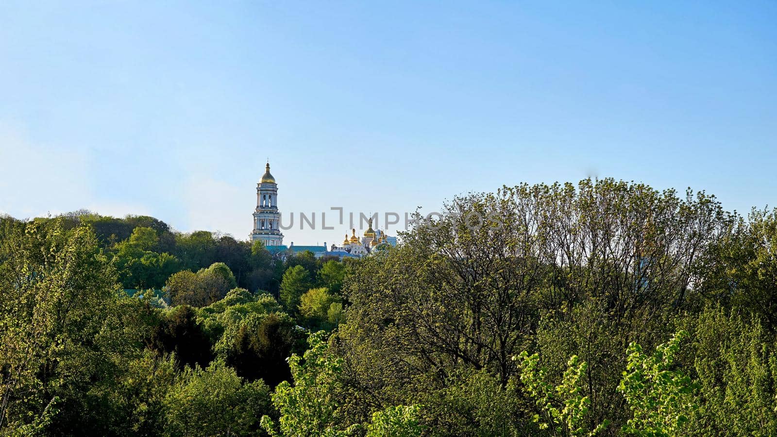 The golden domes of the church and the bright blue sky on a warm Easter day. by jovani68