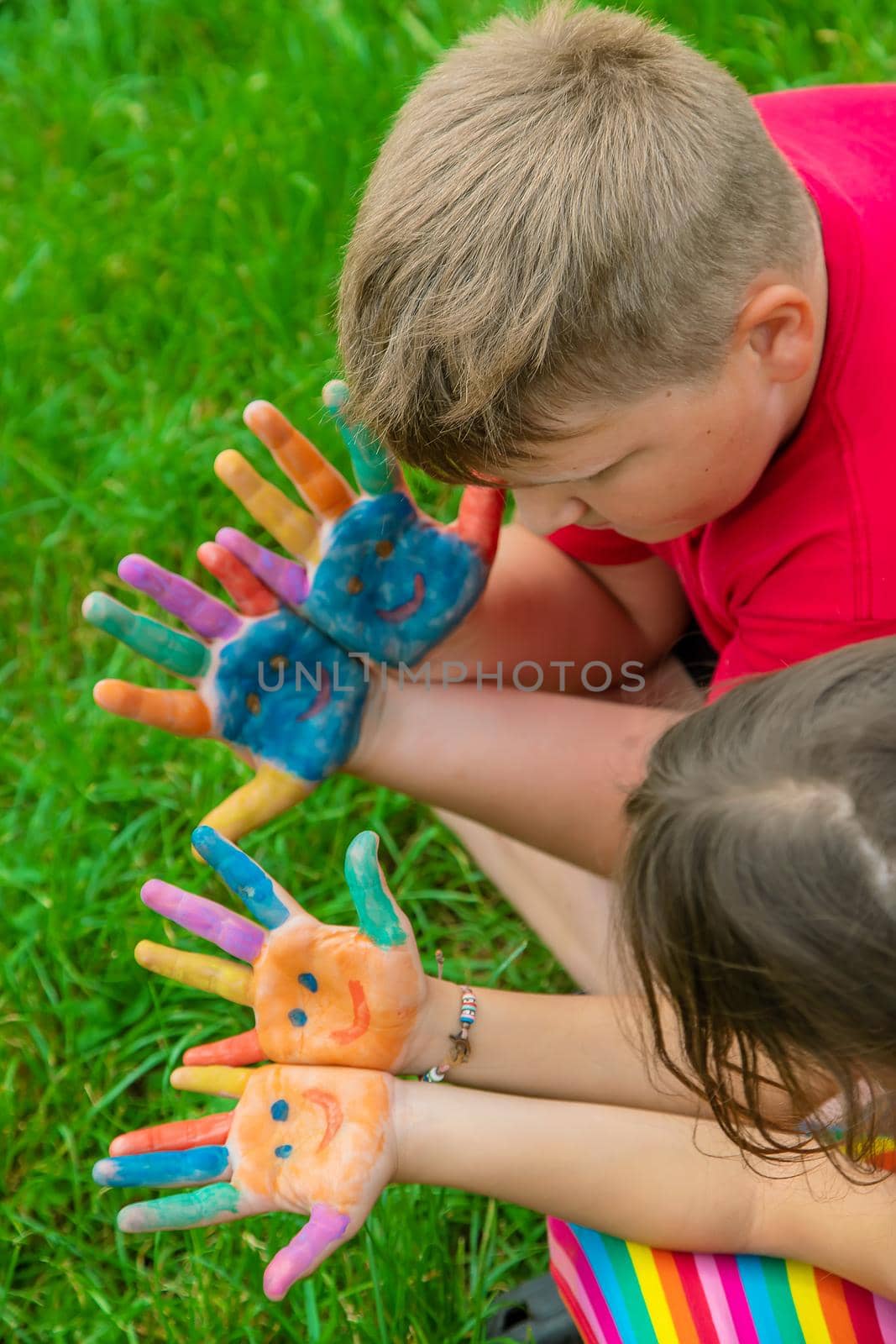 Smile on the hands of a child drawing. Selective focus. Kid.