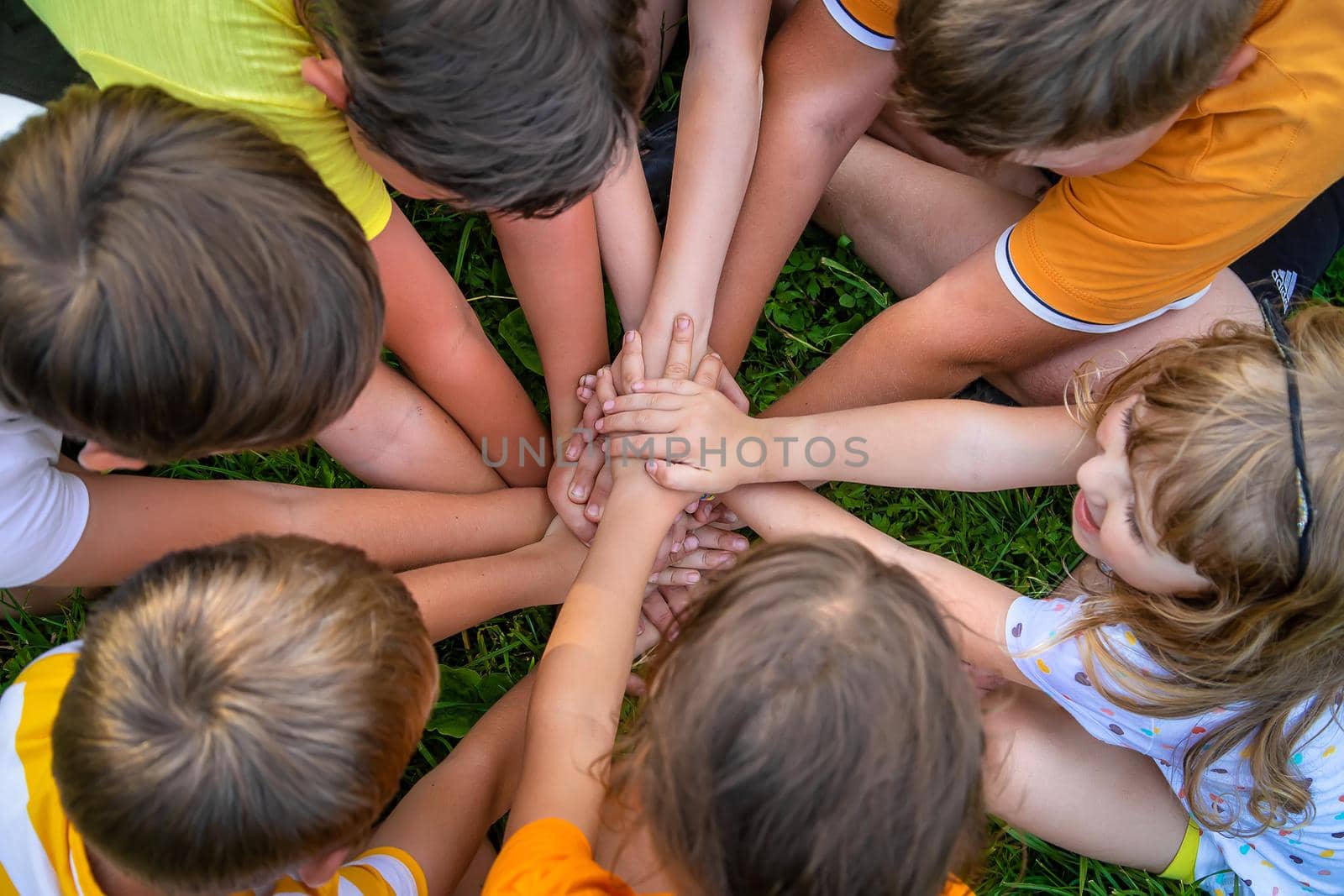 Children are playing with their hands clasped together. Selective focus. Kids.