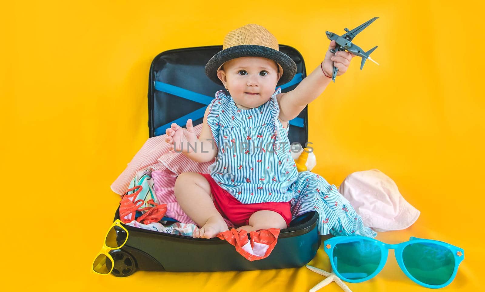Baby and suitcase with things, luggage travel concept. Going on vacation at sea. Selective focus. Child.