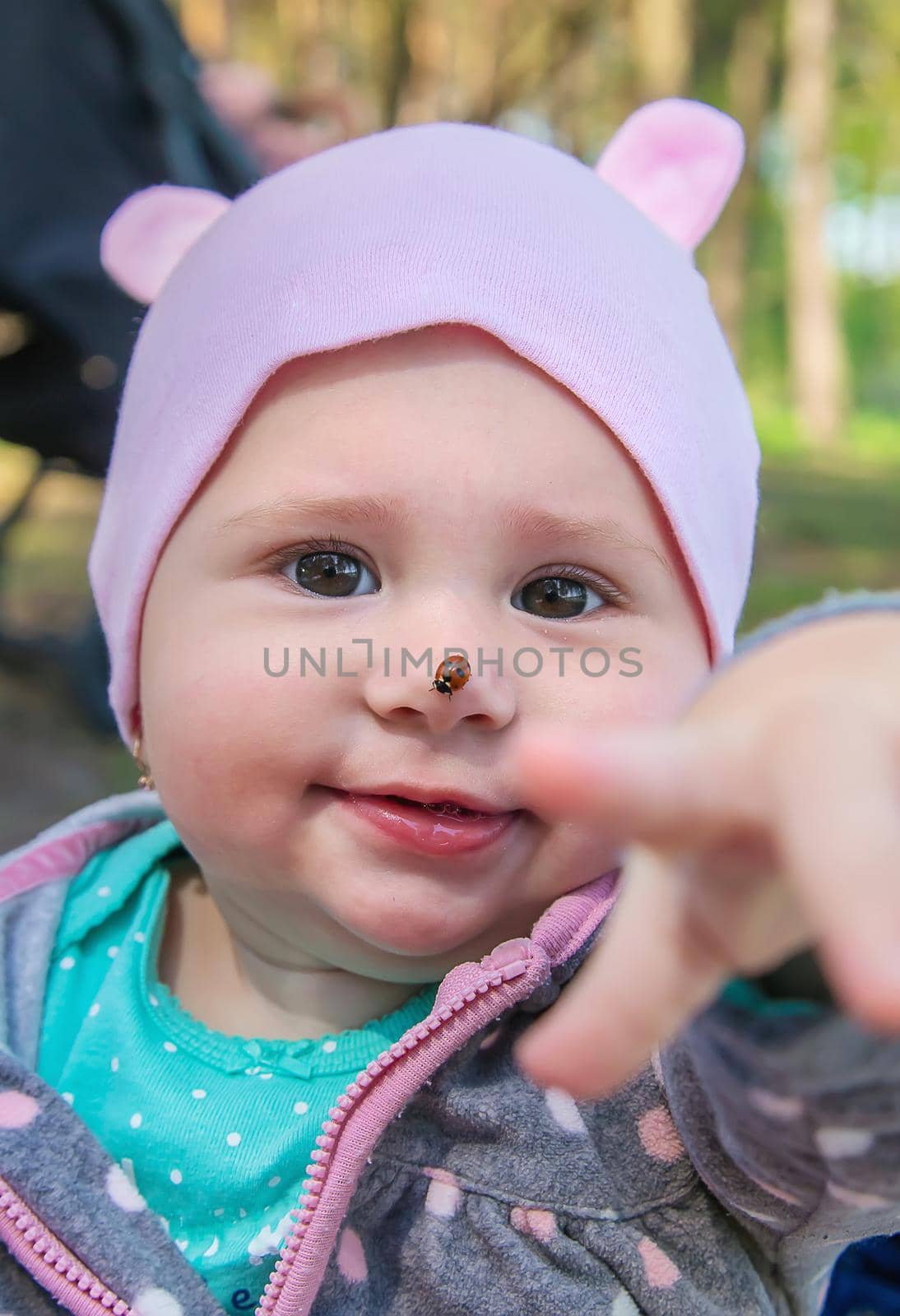 Baby ladybug on the face. Selective focus. by yanadjana