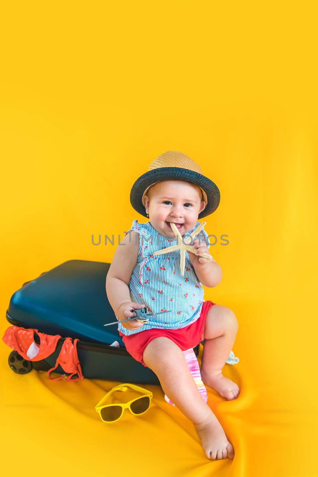 Baby and suitcase with things, luggage travel concept. Going on vacation at sea. Selective focus. Child.