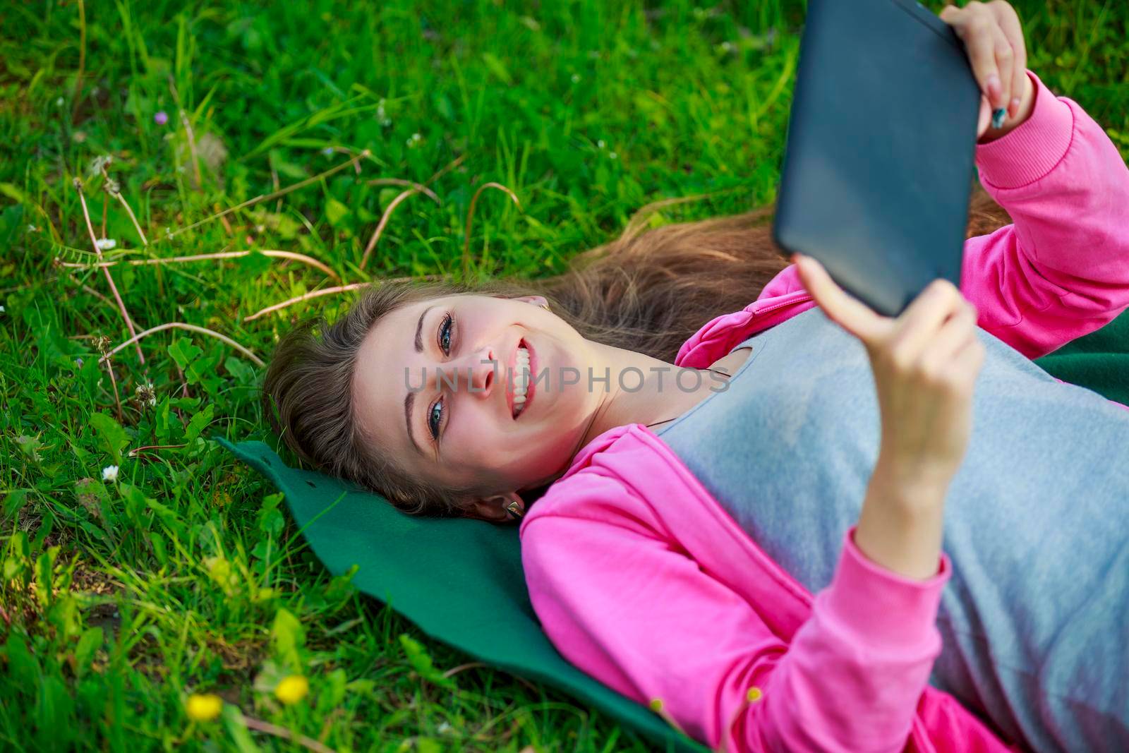 portrait of a girl with a tablet in nature