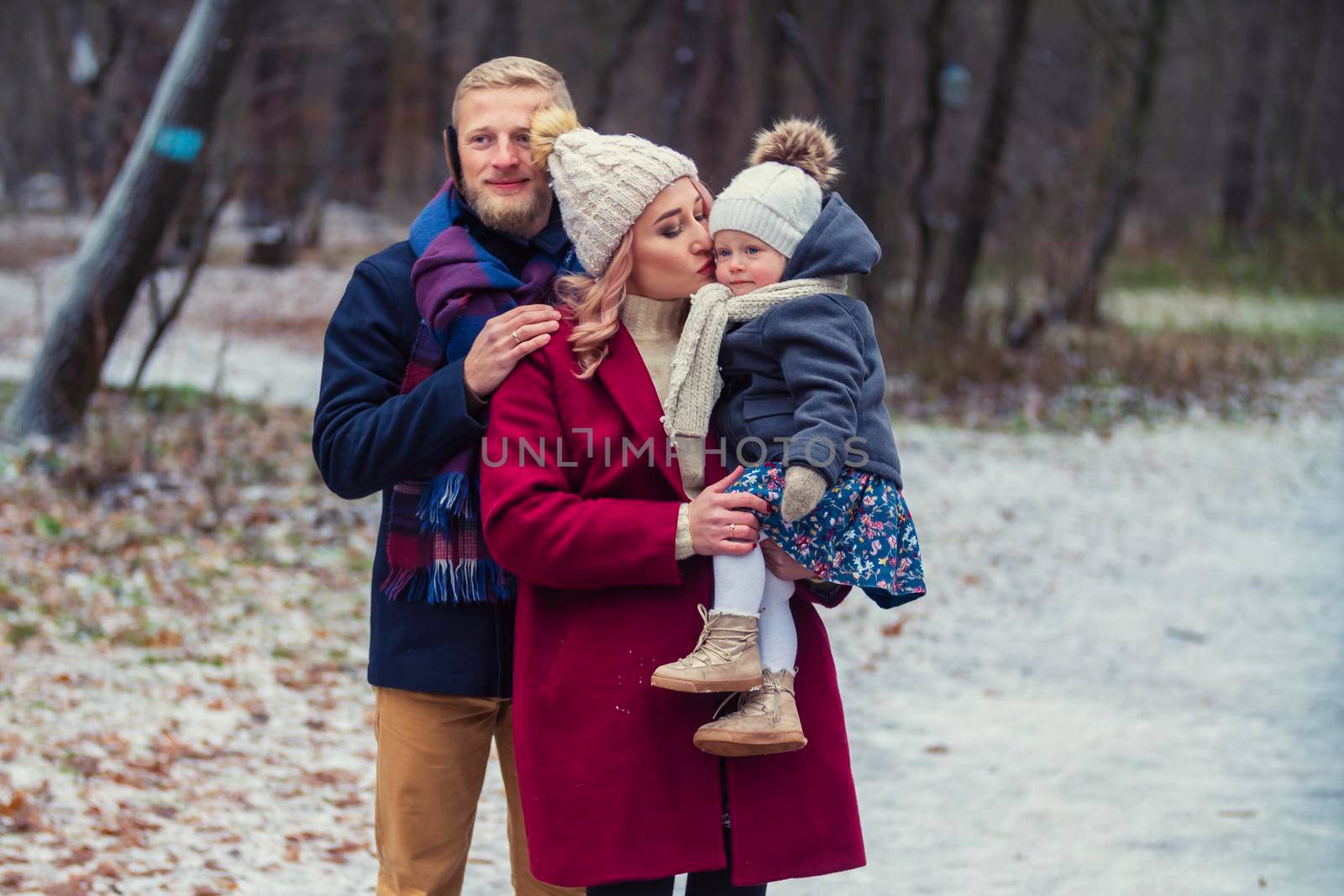 young family walking in the park in winter by zokov