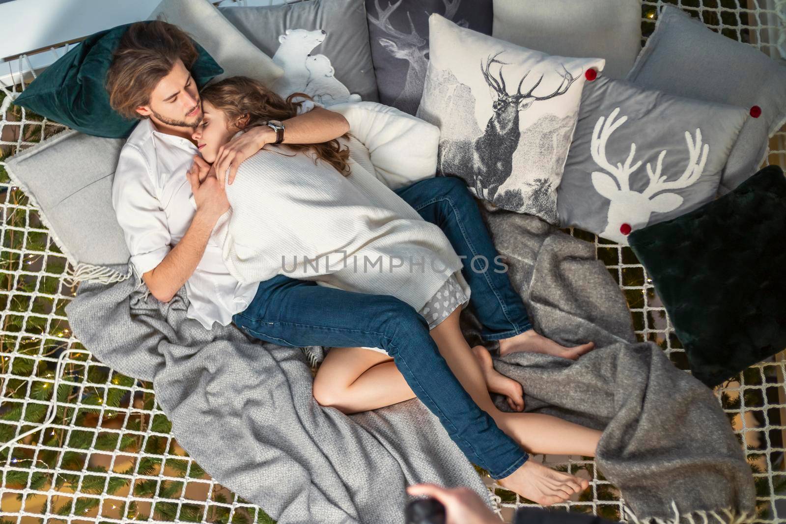 beautiful young couple lies embracing on a stretched net