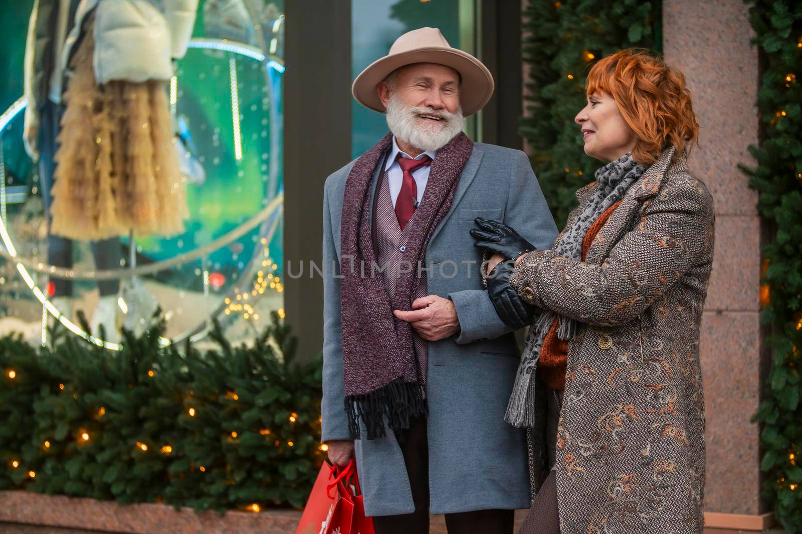 elderly couple on the background of a shop window