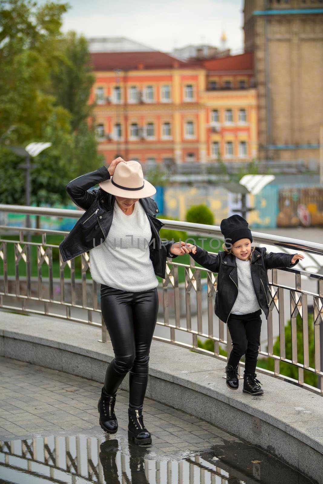 mom and daughter have fun walking around the city