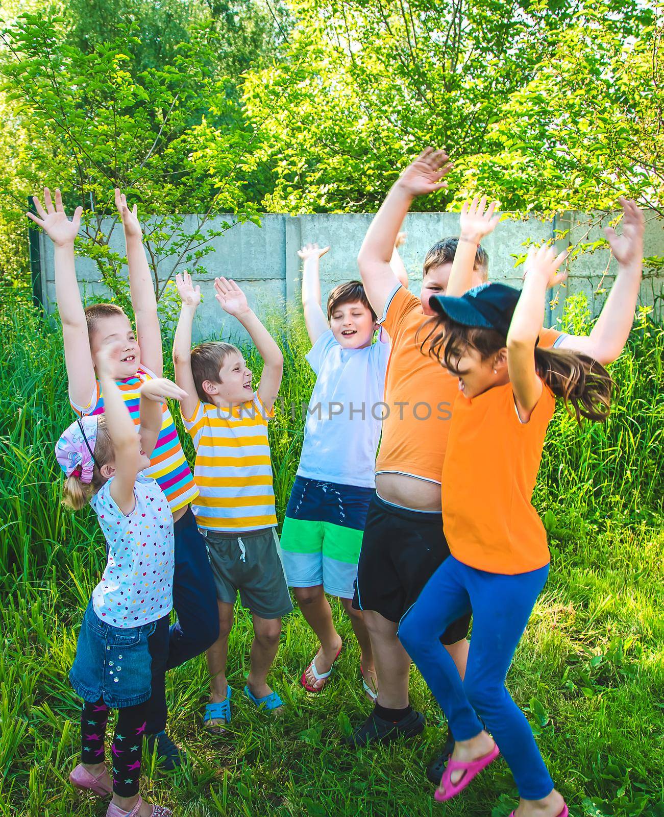 Children are having fun together on the street. Selective focus. by yanadjana