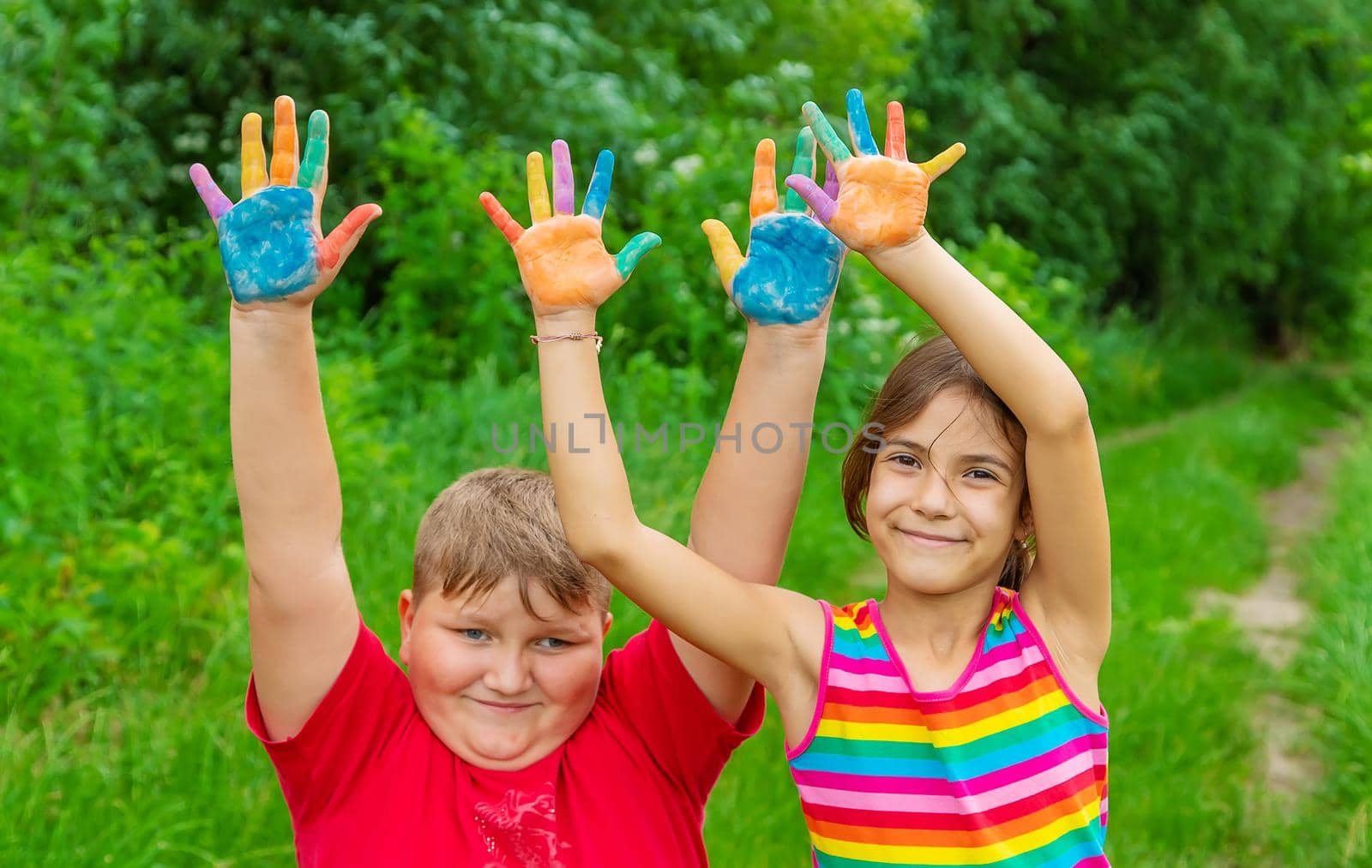 Smile on the hands of a child drawing. Selective focus. Kid.