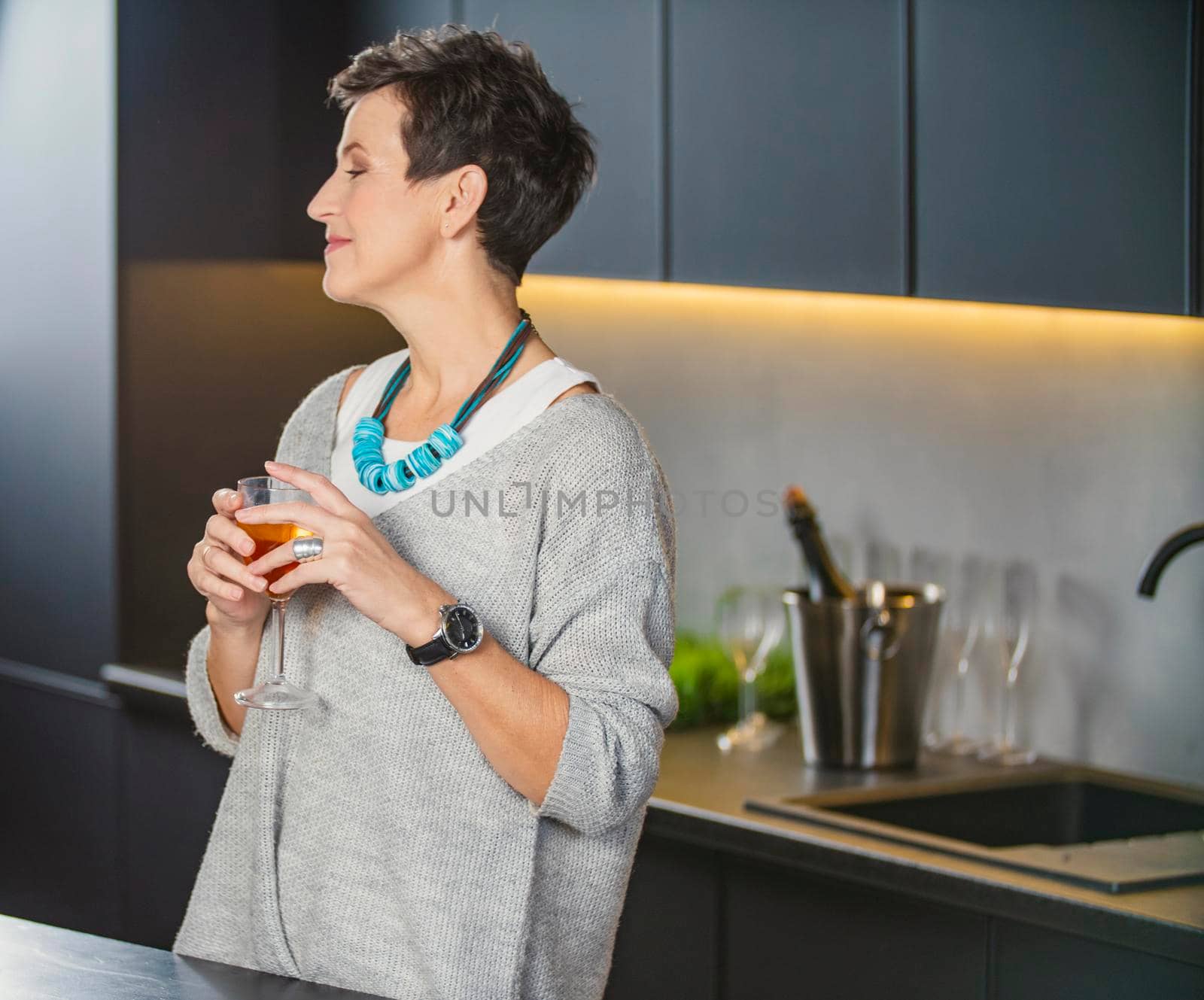 woman with a glass of wine in the kitchen