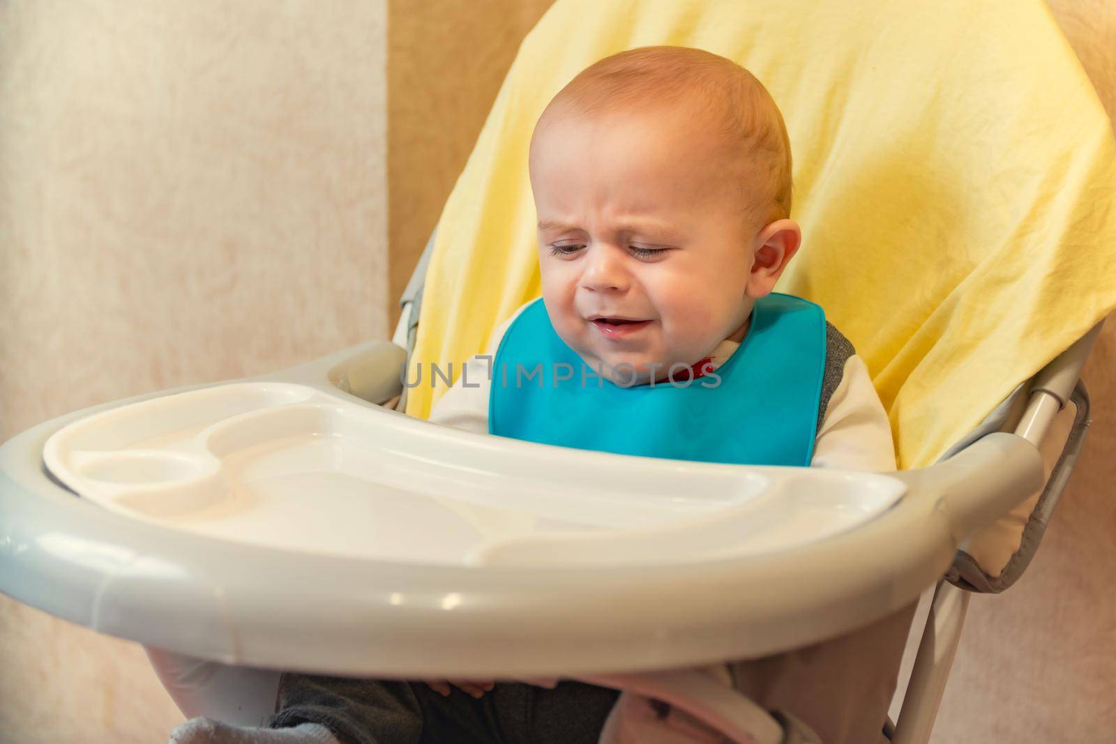 little boy eating sitting at the table