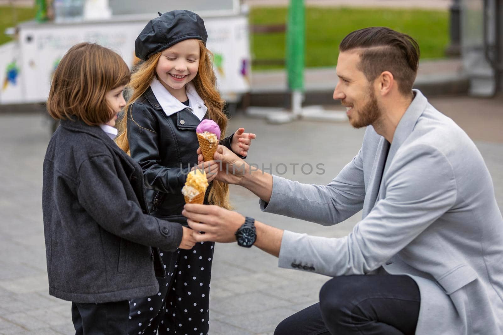 Man gives ice cream to children on the street