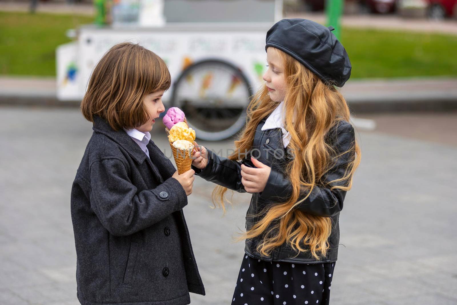 happy kids eating ice cream on the street