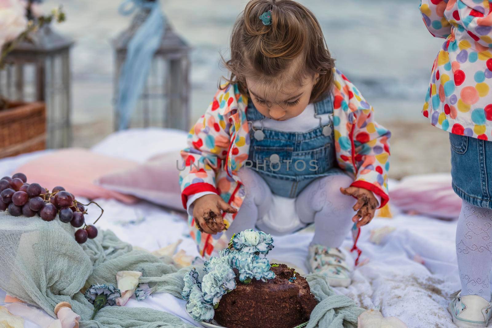 children eat chocolate covered cake with their hands