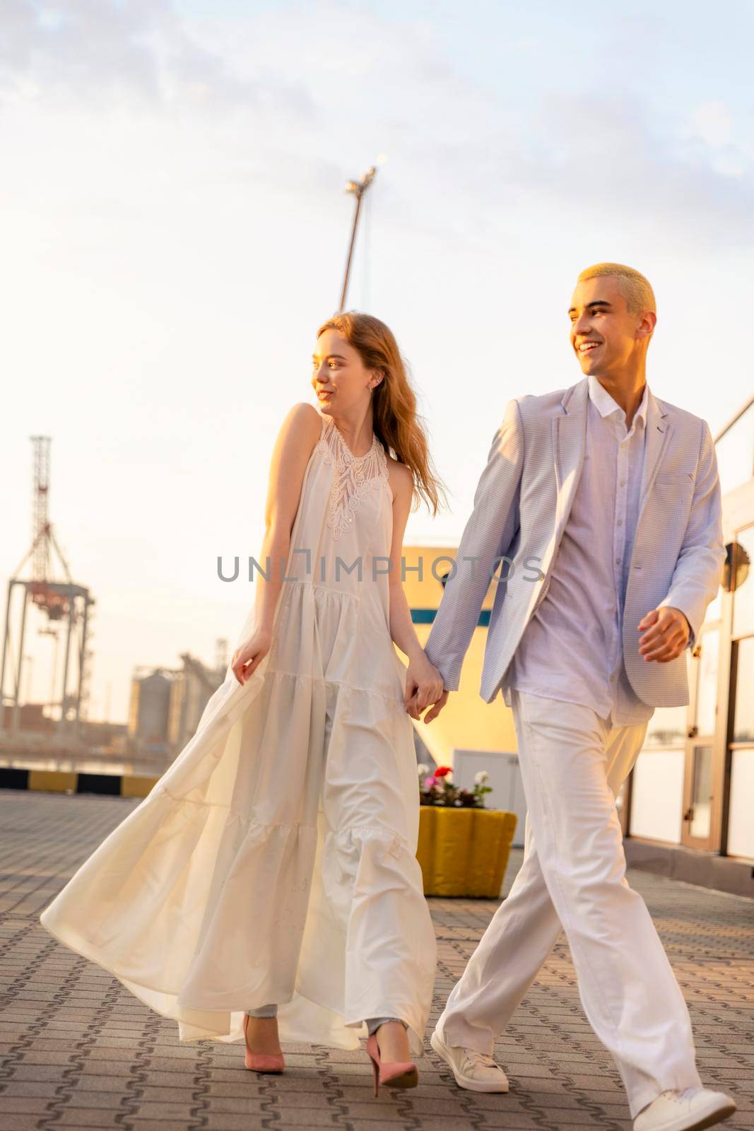 young couple in the seaport on the background of the sea