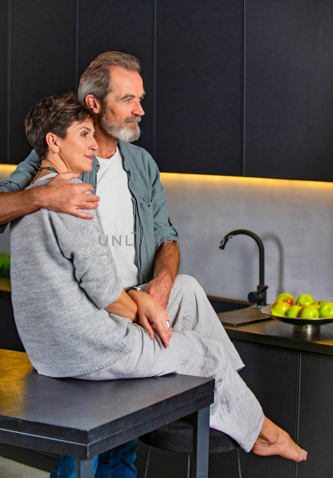 aged couple sitting in the kitchen