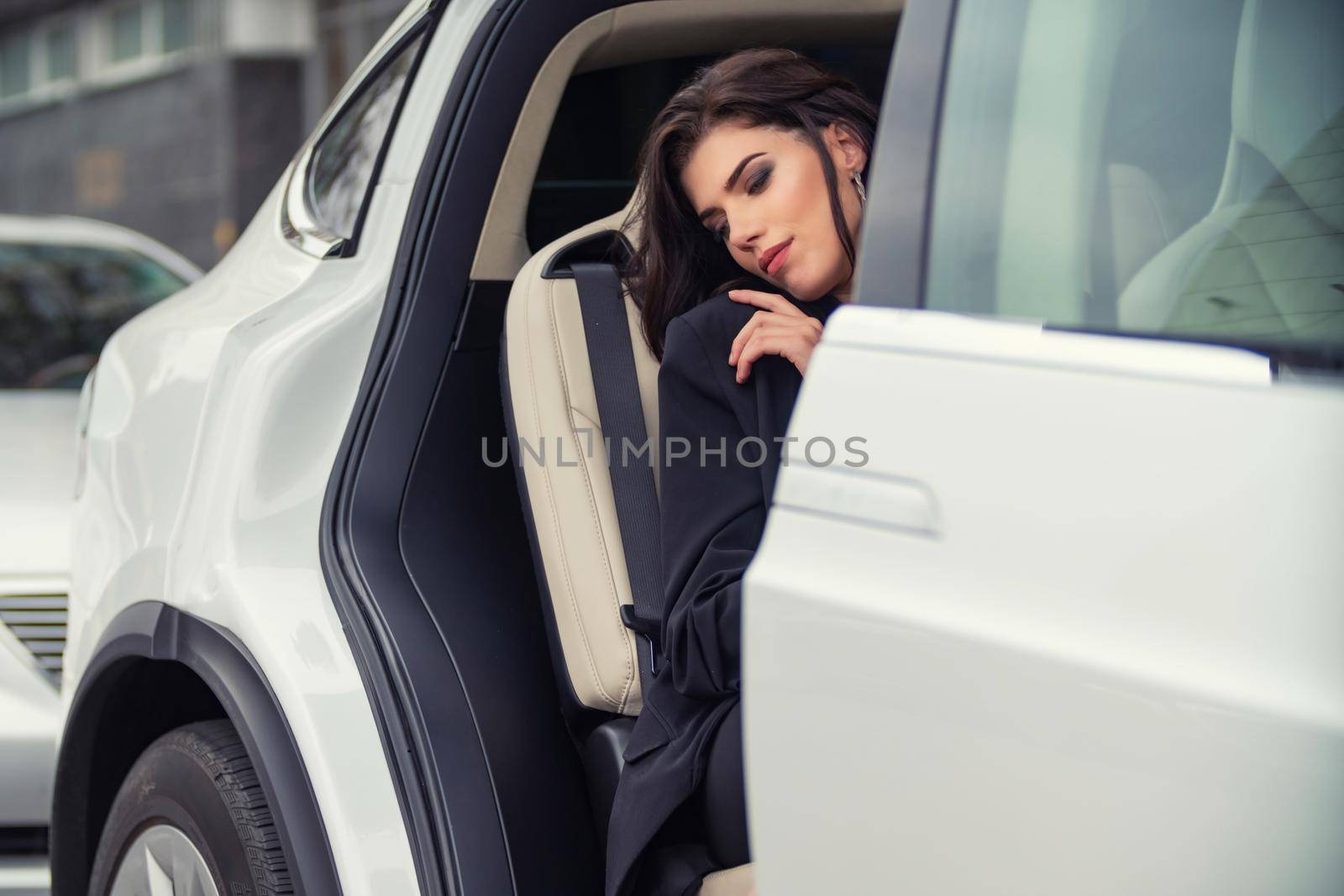 girl sitting in the back seat of the car