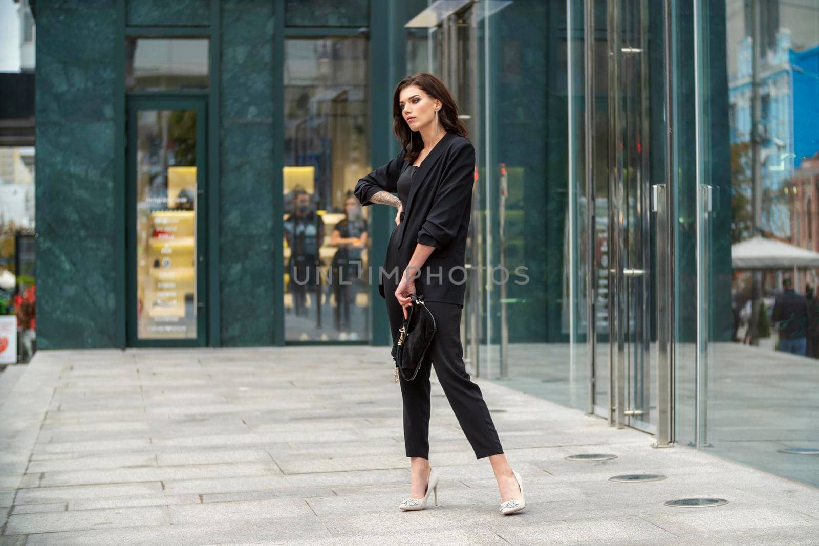 woman in a business suit walking through the city