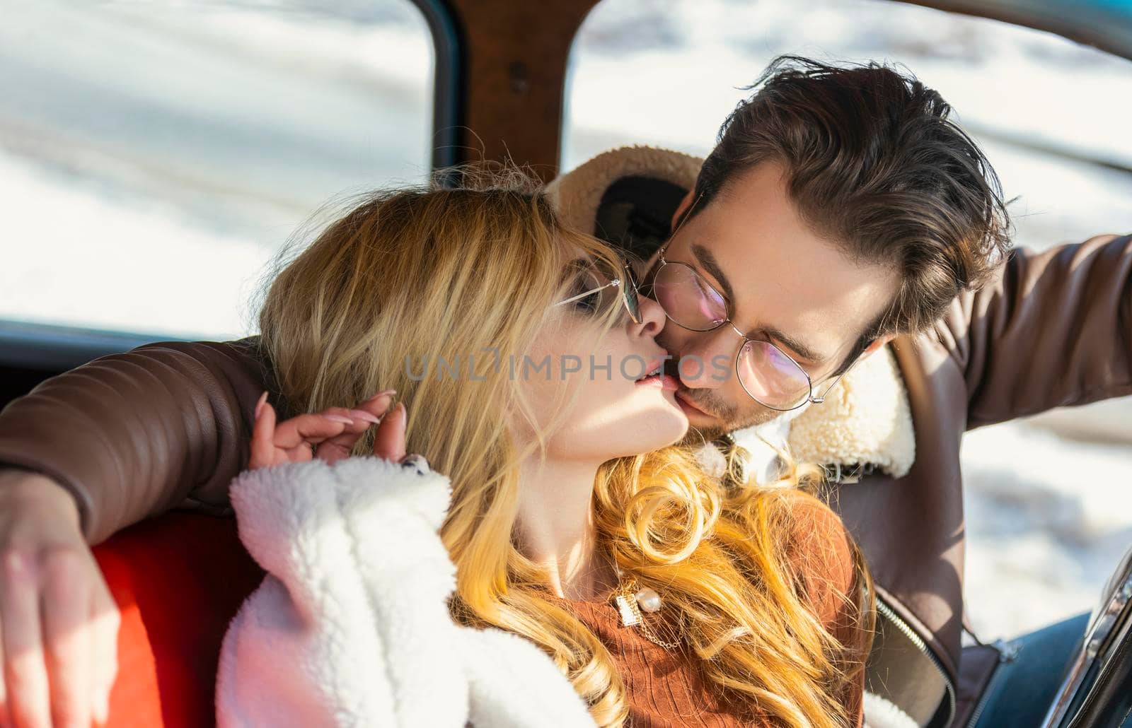 couple kissing in a retro car